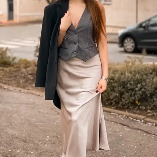 Elegant ladies evening skirt in satin fabric paired with a gray vest and black jacket