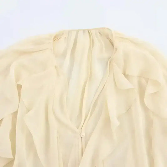Cream sheer fabric with ruffles detail of long sleeve fashionable blouses from The Lady's Haven Boutique
