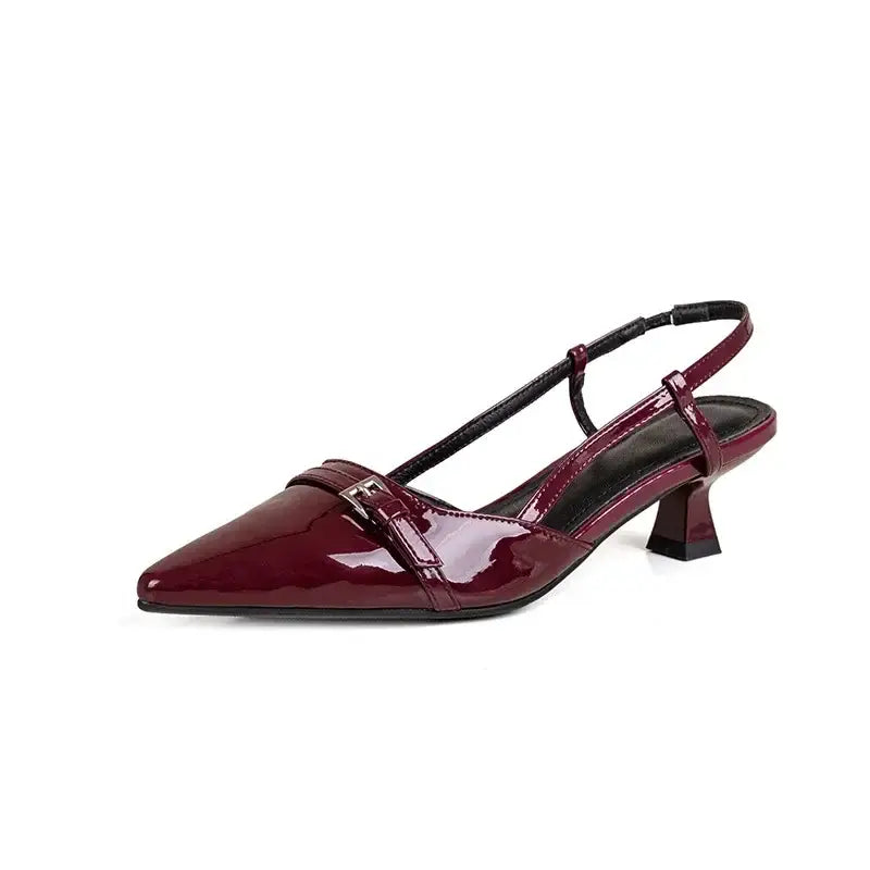 Burgundy patent leather slingback shoe with kitten heel and buckle.
