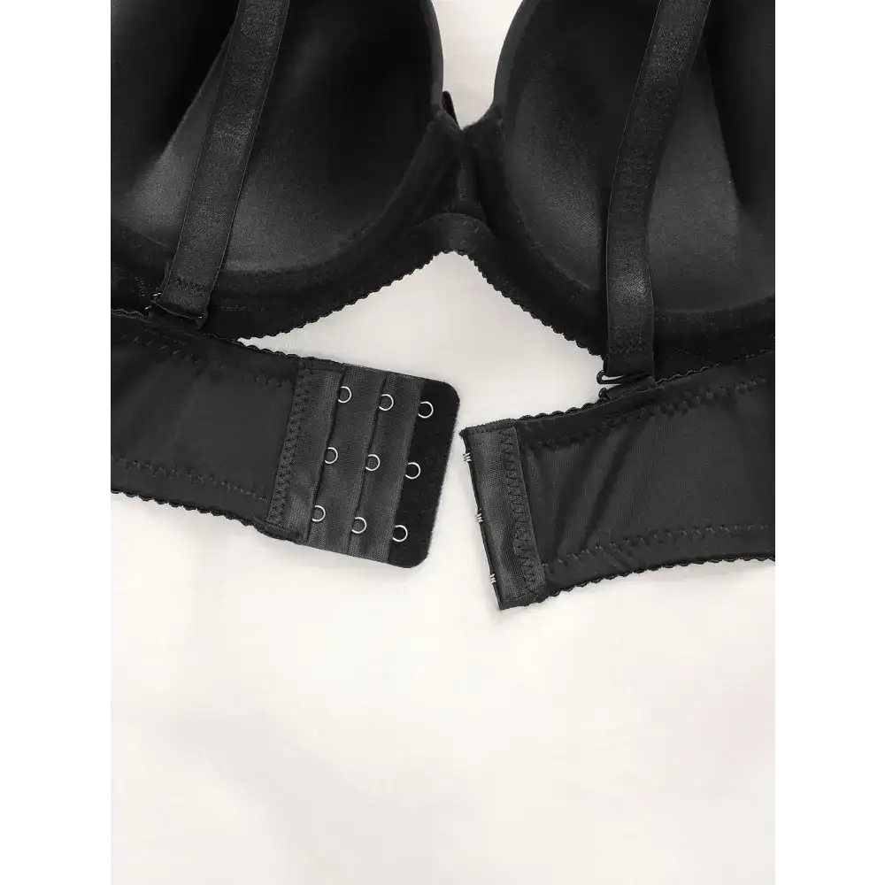 Black adjustable shoulder strap lingerie with hook and eye closure shown from the back