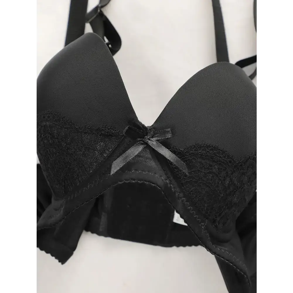 Black lace bra with adjustable shoulder strap lingerie featuring a small front bow detail