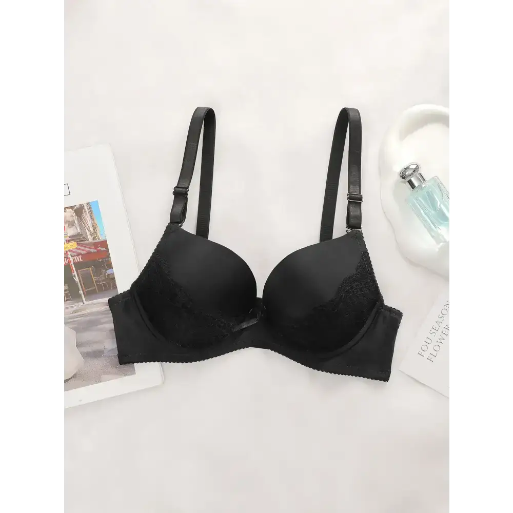 Black bra with adjustable shoulder strap lingerie featuring lace detailing and smooth cups