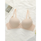 Beige adjustable shoulder strap lingerie bra with textured cups and bow detail from The Lady's Haven Boutique