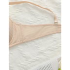 Nude adjustable shoulder strap lingerie bra from The Lady's Haven Boutique laid on white lace fabric