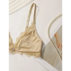 Beige lace adjustable strap wireless bra from The Lady's Haven Boutique laid on a white surface with pearls