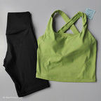 Green crop top and black leggings in a stylish 2 piece workout outfit for activewear enthusiasts