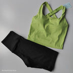 Stylish 2 piece workout outfit featuring a green crop top and black leggings for activewear enthusiasts