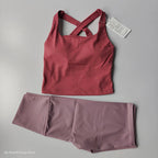 Stylish 2 piece workout outfit with a fitted tank top and matching leggings in pink tones