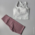 Stylish 2 piece workout outfit featuring a white crisscross tank top and pink leggings