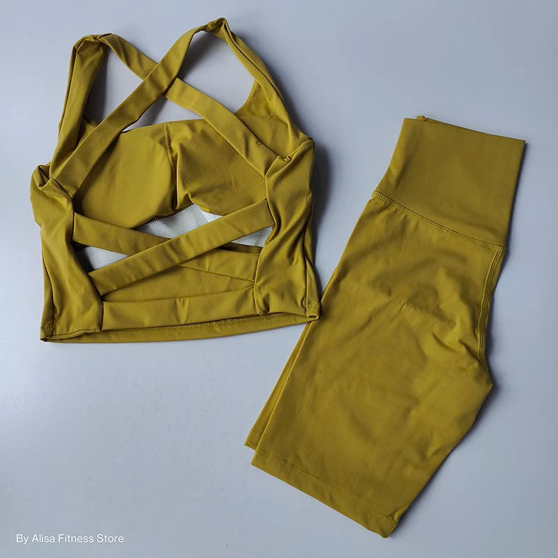Mustard ladies sports bra and shorts set with a stylish crisscross design for activewear