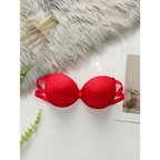 Red anti slip push up bra with lace design and double straps laid flat on white surface