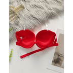 Red anti slip push up bra from The Lady's Haven Boutique displayed on white surface with clear straps