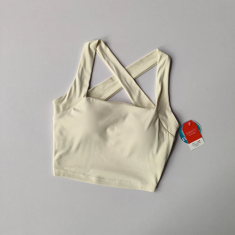 Cream beauty back yoga bra with stylish crisscross straps for comfort during workouts
