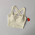 Cream beauty back yoga bra with stylish crisscross straps for comfort during workouts