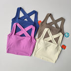 Four stylish beauty back yoga bras in pink, blue, brown and cream for comfort and support