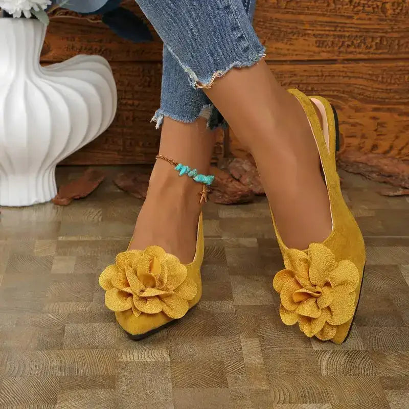 Yellow flat heel big flower embellished sandals from The Lady's Haven Boutique worn with ankle bracelet and blue jeans