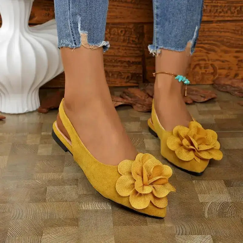 Yellow flat heel big flower embellished sandals from The Lady's Haven Boutique worn with distressed jeans