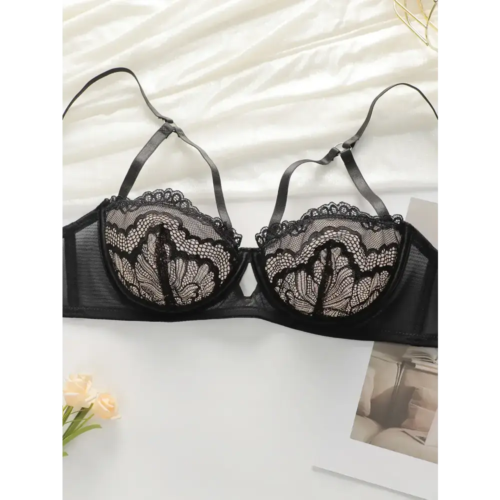 Black lace low waisted thong bra set with delicate floral patterns and adjustable straps