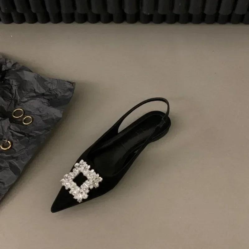 Black pointed toe mid heel sandals with decorative crystal buckle and slingback strap