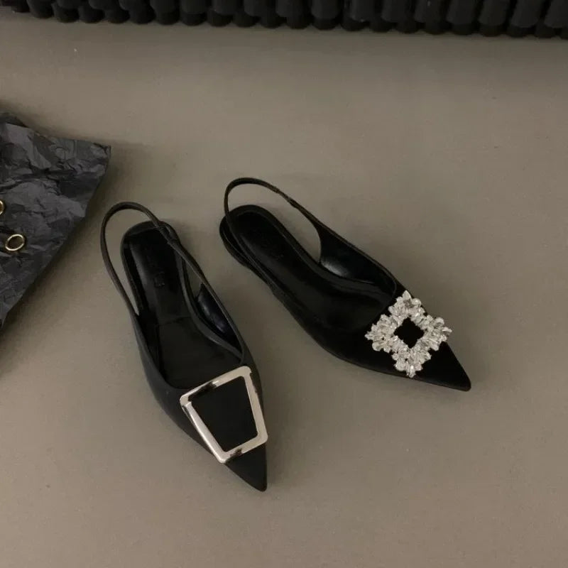 Black pointed toe mid heel sandals with decorative silver buckles from The Lady's Haven Boutique
