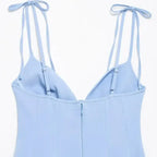 Back view of blue mini party dress with adjustable shoulder ties and zipper closure