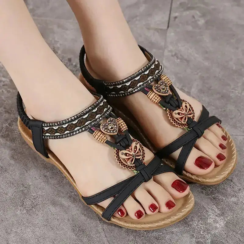 Bohemian beaded summer sandals flat heel from The Lady's Haven Boutique on feet with red nail polish