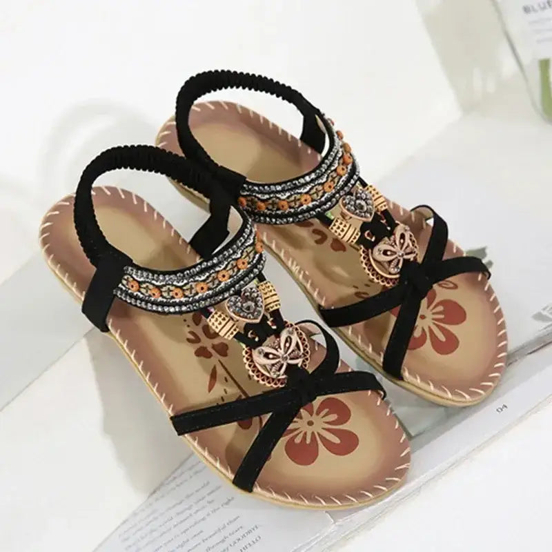Bohemian beaded summer sandals flat heel with black straps and decorative charms from The Lady's Haven Boutique
