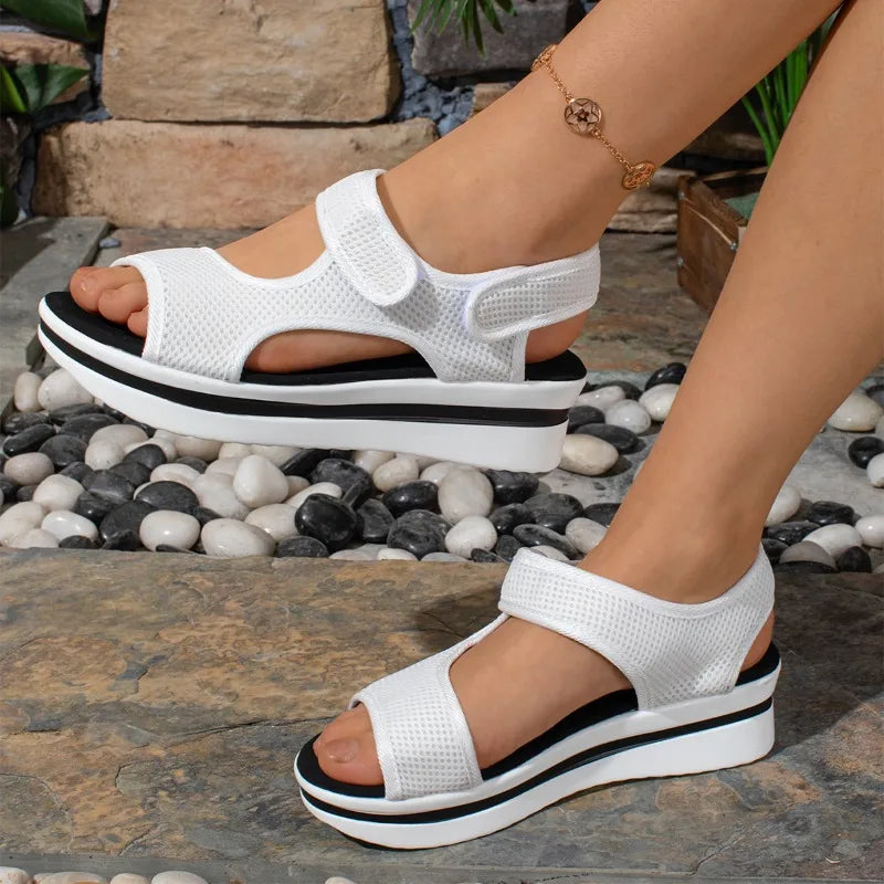 White mesh platform sandals with adjustable straps and black striped sole from The Lady's Haven Boutique