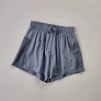 Light gray breathable gym shorts for women with mesh side panels and drawstring waist