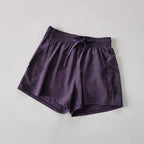 Purple breathable gym shorts for women with mesh pockets and adjustable waistband