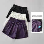 Set of breathable gym shorts for women in black, white, and purple with pockets and breathable mesh design