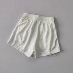 White breathable gym shorts for women with an elastic waistband for comfort and flexibility