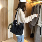 Stylish casual canvas tote bag for women in black being carried by a trendy outfit