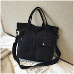 Stylish black casual canvas tote bag for women with two front pockets and a detachable strap