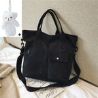 Stylish black casual canvas tote bag for women with exterior pockets and adjustable shoulder strap