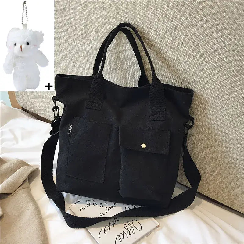 Stylish black casual canvas tote bag for women with exterior pockets and adjustable shoulder strap