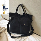 Stylish black casual canvas tote bag for women with dual front pockets and adjustable shoulder strap