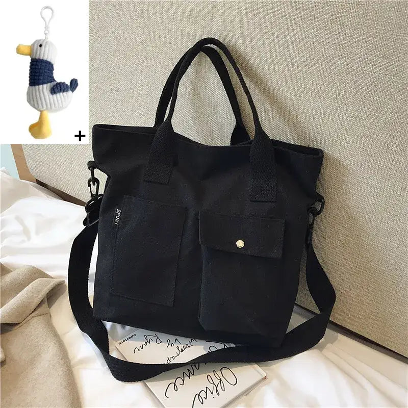 Stylish black casual canvas tote bag for women with dual front pockets and adjustable shoulder strap