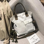Stylish casual canvas tote bag for women with adjustable straps and front pocket design