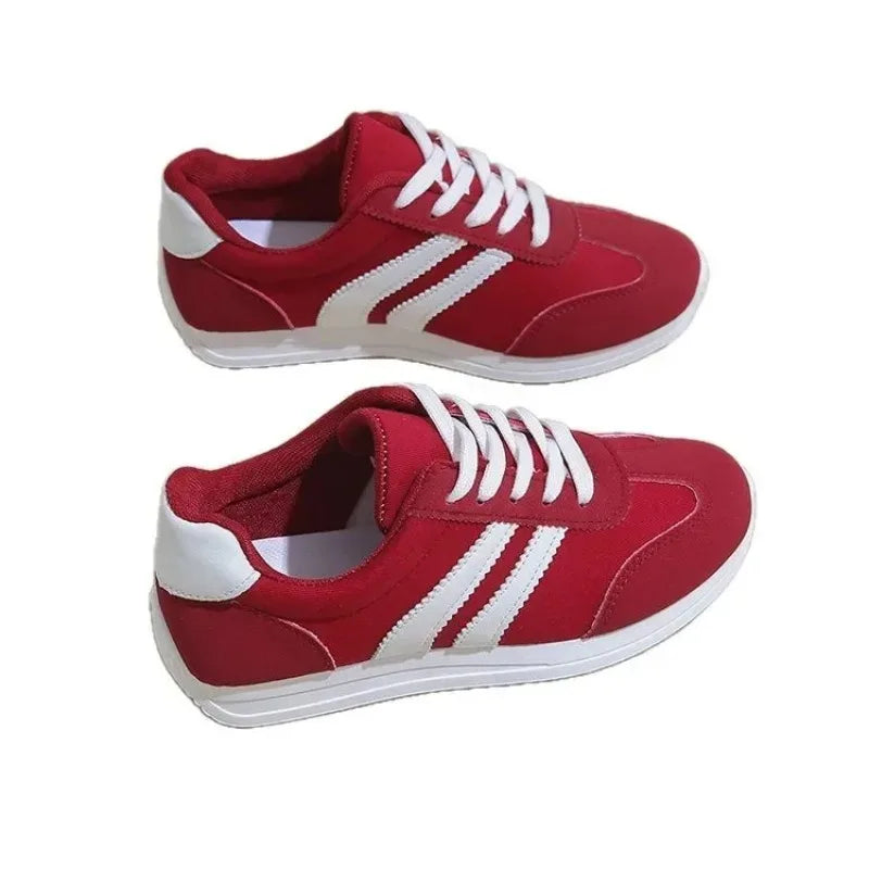 Red casual slip on sneakers with white stripes and laces from The Lady's Haven Boutique