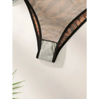 Close-up of comfortable animal print lingerie with sheer fabric and black trim by The Lady's Haven Boutique