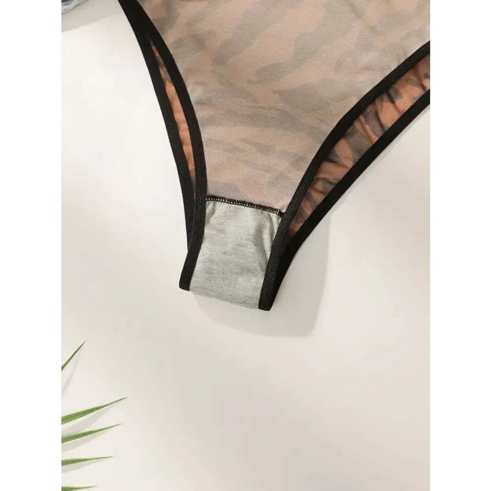 Close-up of comfortable animal print lingerie with sheer fabric and black trim by The Lady's Haven Boutique