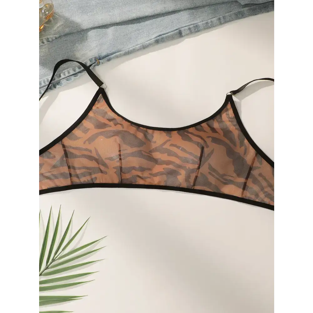 Comfortable animal print lingerie bralette with black trim straps laid flat on a white surface