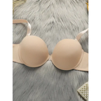 Beige comfortable steel ring lingerie for women bra laid on gray fur fabric background