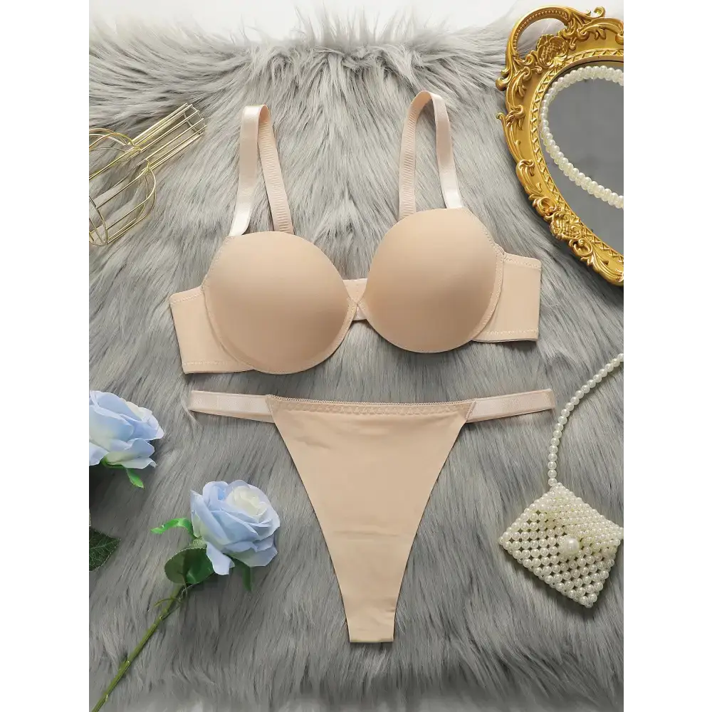 Beige comfortable steel ring lingerie for women set with bra and thong on gray fur background