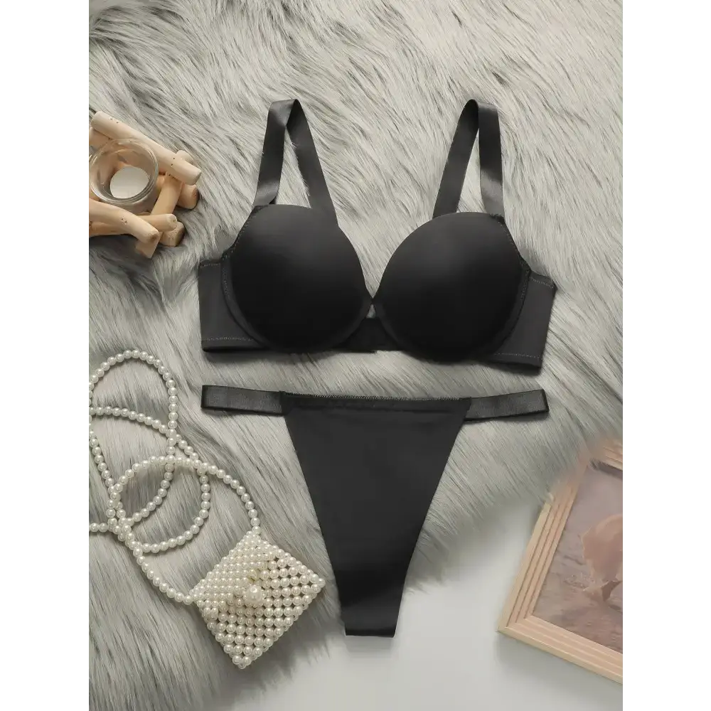 Black comfortable steel ring lingerie for women set with bra and thong on fur background