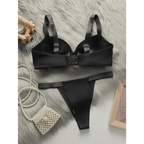 Black comfortable steel ring lingerie for women set with bra and matching thong on fur background