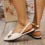 The Lady's Haven Boutique flat heel sandals in beige with bow detail and comfortable summer pointed toe shoes