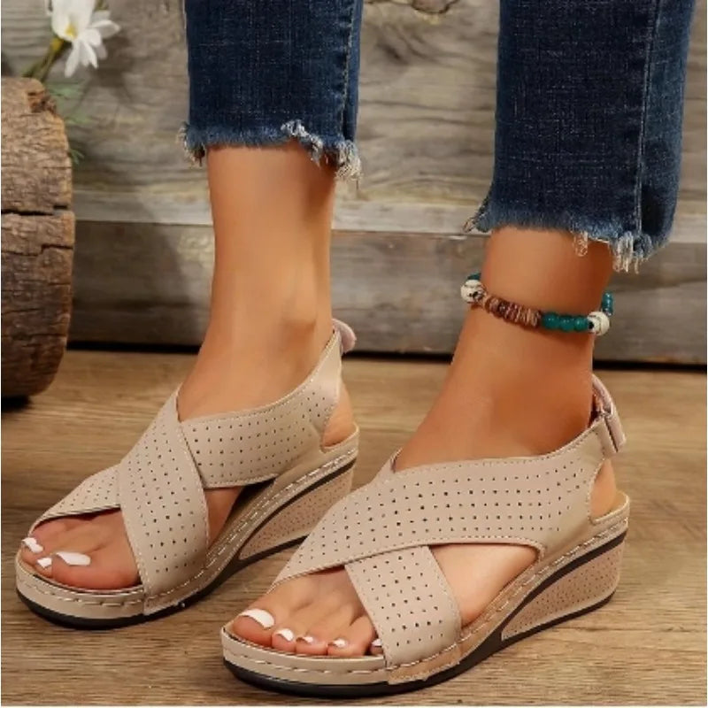 Beige comfortable walking sandals for ladies with perforated crisscross straps and wedge heel