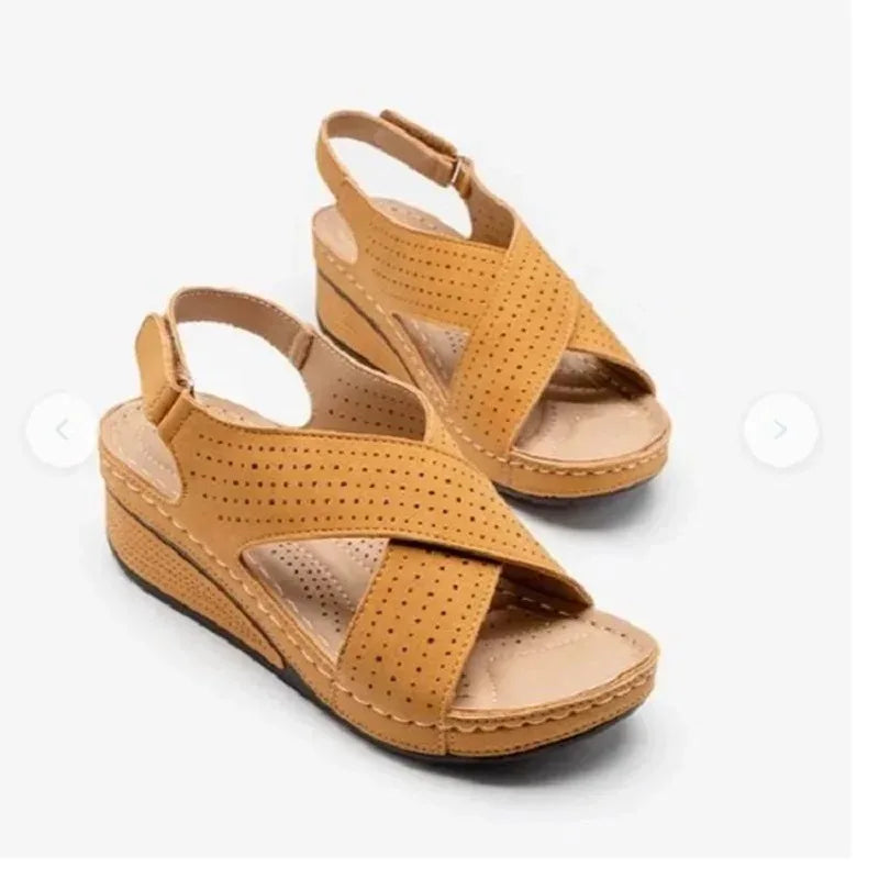 Tan comfortable walking sandals for ladies with perforated crisscross straps and cushioned wedge sole